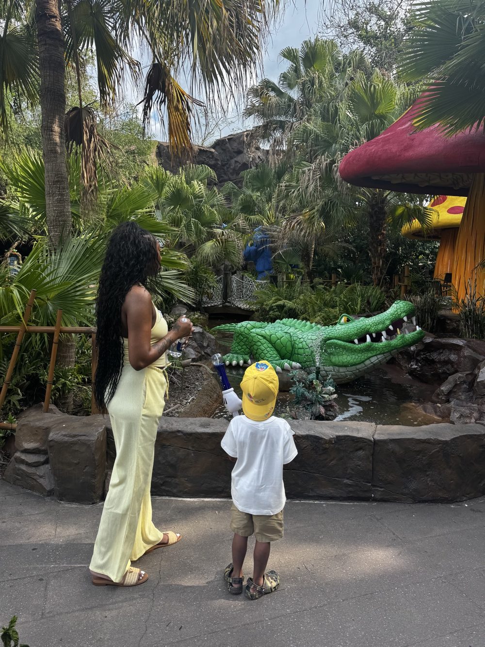 A mother and her little boy enjoying a theme park adventure